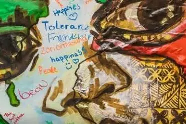 Artwork showing a face painted with words overlaid in different languages